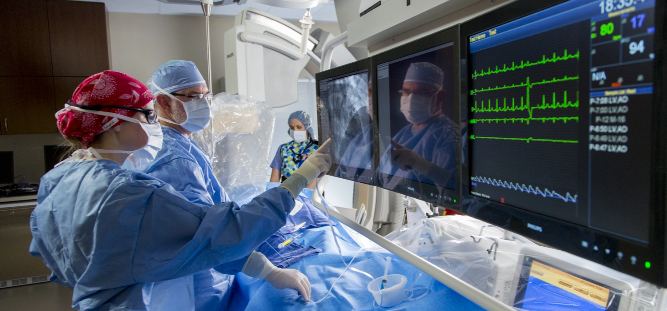 stock-photo-doctor-is-examining-heart-s-patient-by-echocardiogram-for-diagnosis-disease-or-explain-symptom-1952004073 cathlab
